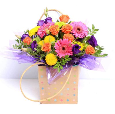 This vibrant bouquet of fresh, hand tied flowers is almost as much fun as a trip to the carnival and combines Germini, Chrysanthemum, Lisianthus and Roses to stunning effect. A perfect example of beautiful flowers at their finest! This bouquet will be handcrafted by an experienced florist, order for same day delivery by hand, or next day delivery via our courier.