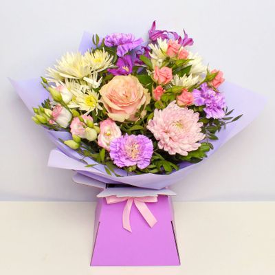 Our popular pastel giftbox is here to please! Pastel stems including spray roses, cyrsanthemum, carnation, clematis and lisianthus make up this beautiful summer bouquet. Cut and tied by hand, this bouquet is bursting with summer stems to make them smile. This bouquet will be handcrafted by an experienced florist, order for same day delivery by hand, or next day delivery via our courier.