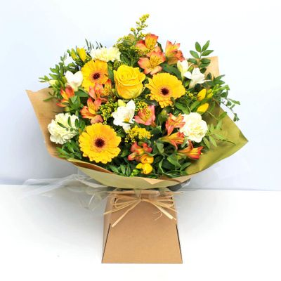 Our dazzling Sunshine Giftbox is certain to brighten even the darkest day, with bright pops of yellow and orange. This bouquet will be handcrafted by an experienced florist, order for same day delivery by hand.